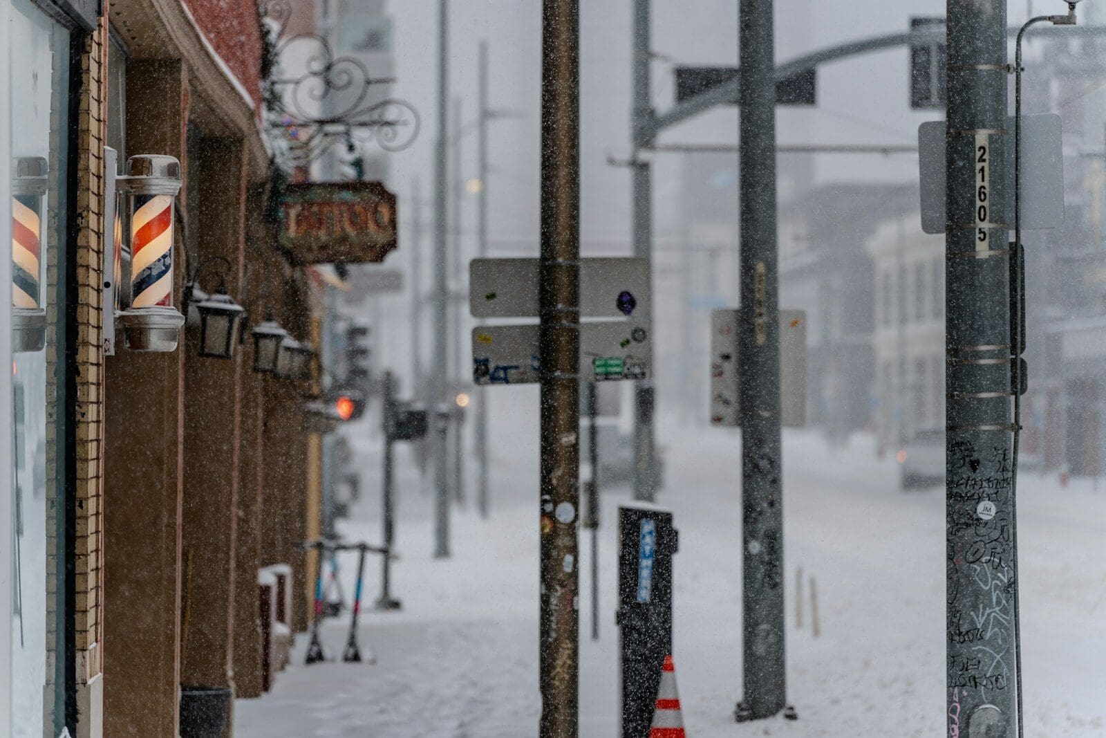 A city street with a bunch of traffic lights on a snowy day